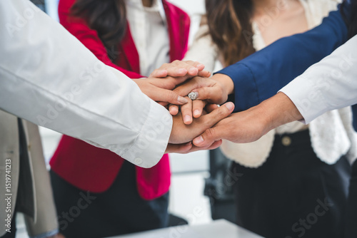 Photos Business people stacking hands together, demonstrating teamwork, collaboration,