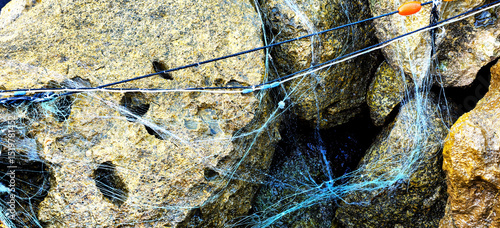 Sea torn fishing net on rocks. Summer sea fishing
Fishing background
