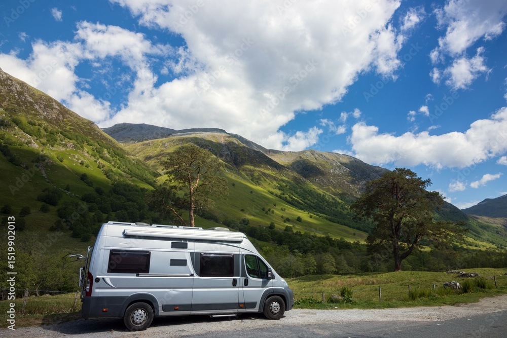 Fototapeta premium Camper van parking on the road at the popular Glencoe valley in the Scottish highlands, Scenic Routes