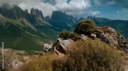 Wallpaper Mural Dramatic mountain landscape with rocky terrain, trees and layers of rolling hills against a cloudy blue sky in a scenic environment Torontodigital.ca
