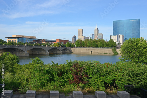 Old Washington Street Bridge, White River, and downtown Indianapolis skyline from park. Indiana, United States