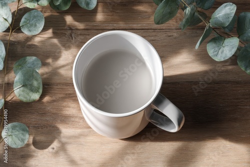 White Mug on Table Top and Green Leaves