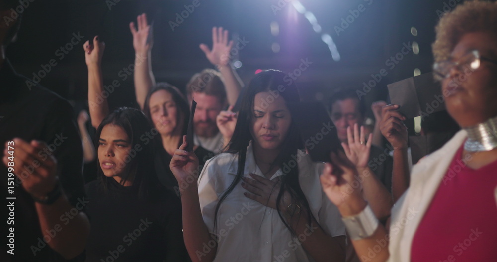 Fototapeta premium Diverse congregation raising offering envelopes during emotional prayer, immersed in worship and deep spiritual reflection