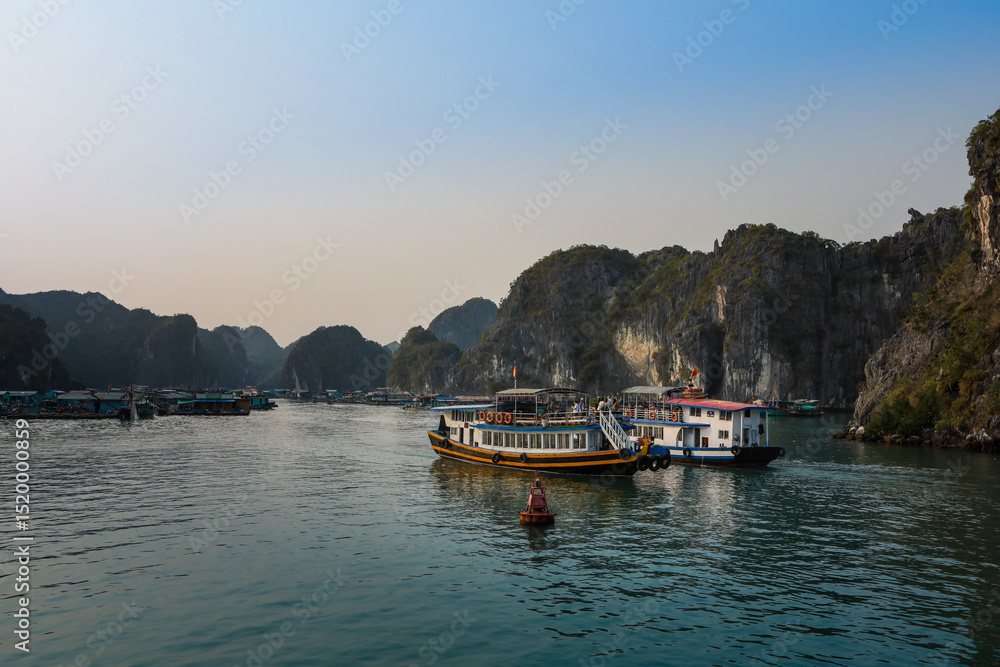 Naklejka premium Beautiful panorama of Lan Ha bay, Ha Long, Vietnam, with many limestone karst islets and turquoise sea water.