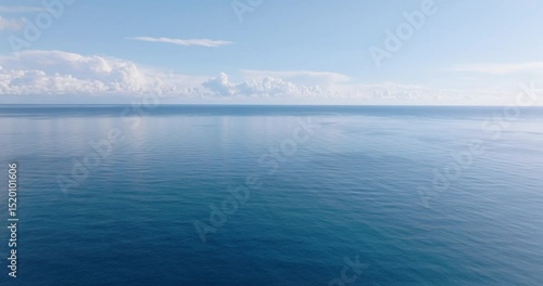 Aerial view of an ethereal cloudy sky above the deep blue sea during the daytime.