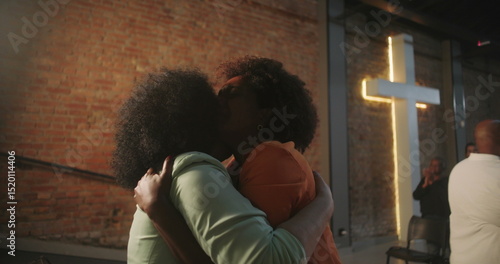 Photography Congregation members sharing an emotional embrace during a Christian event, expr