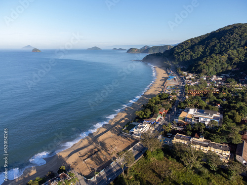 Amazing lighting on orange sand beach and strong waves in coastal village