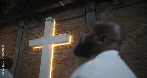 Fotografie Person in congregation attending church service, looking up with spiritual refle