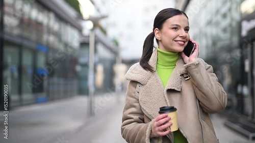Beautiful woman walking outdoor and talking on phone