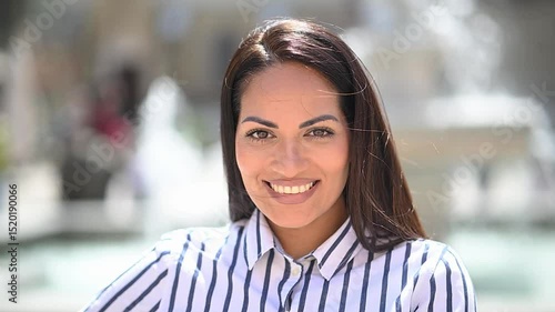 Portrait of beautiful woman standing outdoor and loking at camera