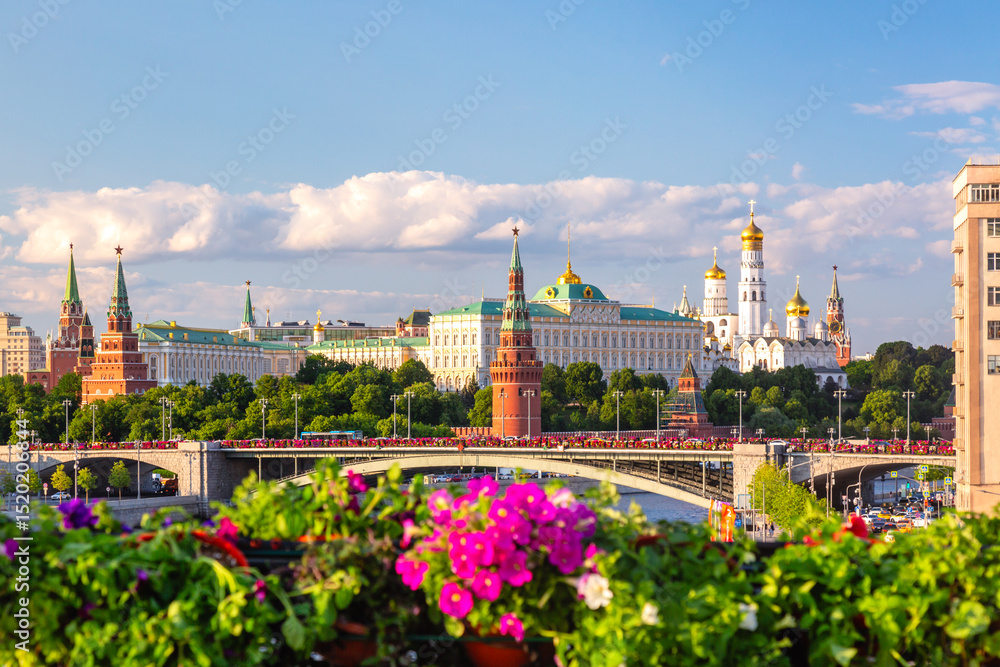 Fototapeta View of Moscow Kremlin, Moscow River and Big Stone bridge with pink flowers on the foreground during summer sunny day