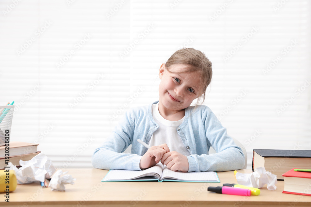 Little girl doing homework at table indoors Little girl doing homework at table indoors