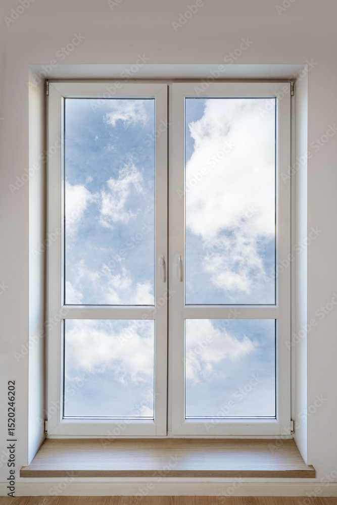 Modern white PVC window with double insulated panes in bright living space Modern white PVC window with double insulated panes in bright living space