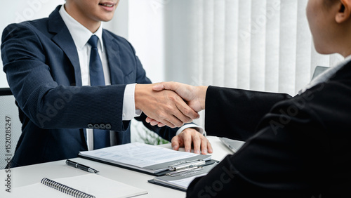Photography Man employer in suit shaking hands to congratulate with the new employee after s