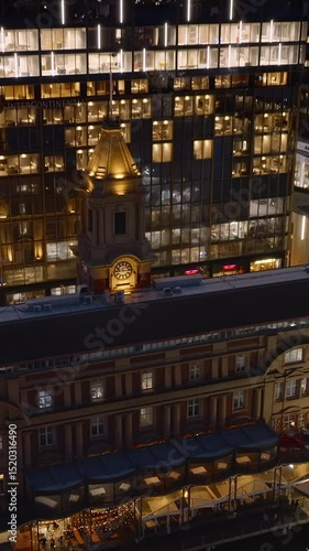 Wallpaper Mural Night view of a Hotel and clock tower in Auckland New Zealand. The hotel is lit up, and the clock tower is illuminated. The image captures the city's architecture. Torontodigital.ca