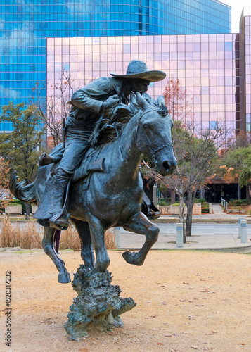 Canvas Print Bronze sculpture of a trail boss on his horse at Pioneer Plaza public park In Da