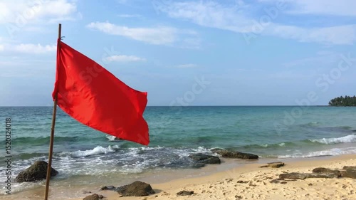 Red Warning Flag on Sandy Beach by Ocean Waves
