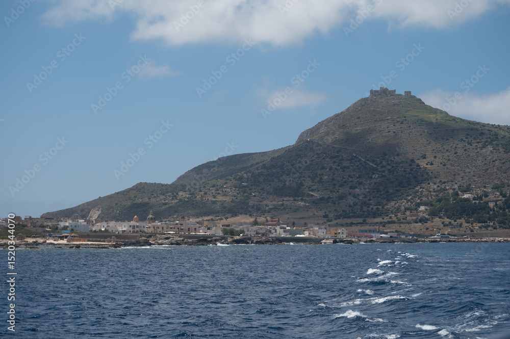Boat trip and view on coastline of Favignana island with small village, shallow bays with clear turquoise water, tuff rocks, abandoned quarries, caves, Egadi Islands near Sicily, Italy Boat trip and view on coastline of Favignana island with small village, shallow bays with clear turquoise water, tuff rocks, abandoned quarries, caves, Egadi Islands near Sicily, Italy