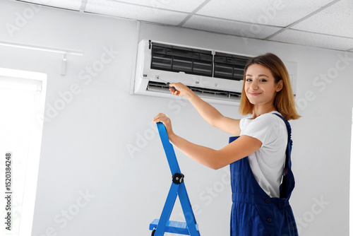 Female technician fixing ai...