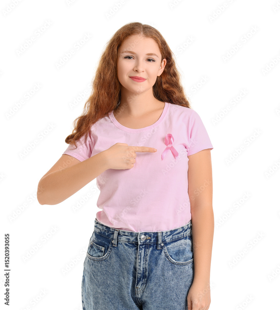 Fototapeta premium Young redhead woman pointing at awareness pink ribbon on white background. Breast cancer concept