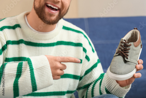 Happy young man pointing at...