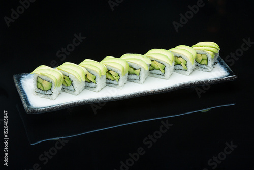 cucumber avocado inside-out sushi roll on the plate