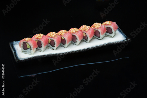 fresh tuna avocado inside-out sushi roll on the plate