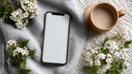 Blank Smartphone Screen Mockup with White Flowers and Greenery on a Textured White Background