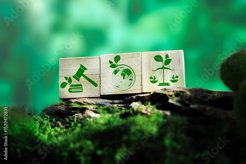 Sustainable law and eco justice icons on wooden cubes over green forest background representing environmental rights