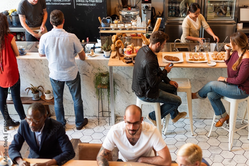 Fototapeta premium A busy cafe with diverse people enjoying coffee and pastries. Customers sit and chat, while baristas prepare drinks. A lively, social cafe atmosphere. Diverse people at a coffee shop.