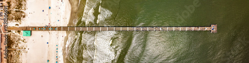 Aerial view of the Jacksonville Beach Pier in north Florida on a summer afternoon.