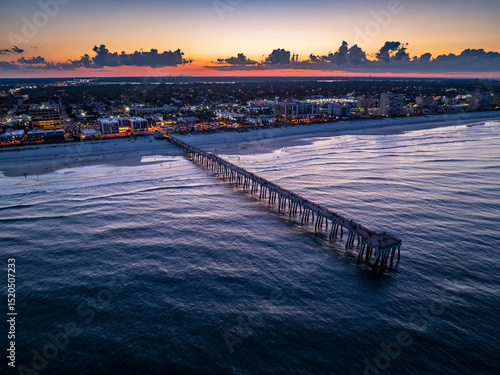Aerial view of the Jacksonville Beach Pier in north Florida at dusk.