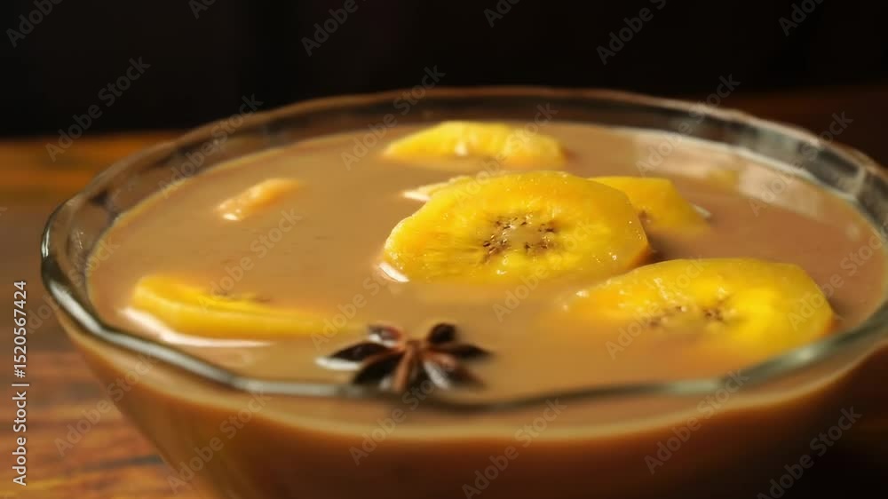 Dessert in bowl featuring banana slices and a star anise Dessert in bowl featuring banana slices and a star anise
