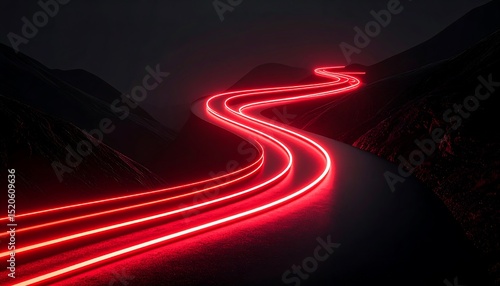 Winding red light trails on a dark mountain road