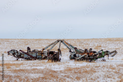 Fotografia Collection of threshing machines in a snowy North Dakota field