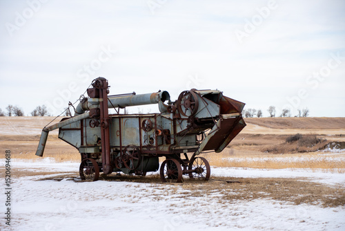 J. I. Case threshing machine in a snowy North Dakota field