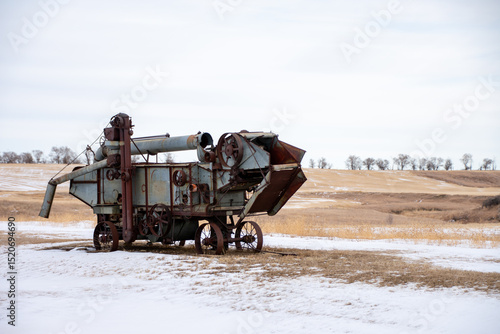 J. I. Case threshing machine in a snowy North Dakota field