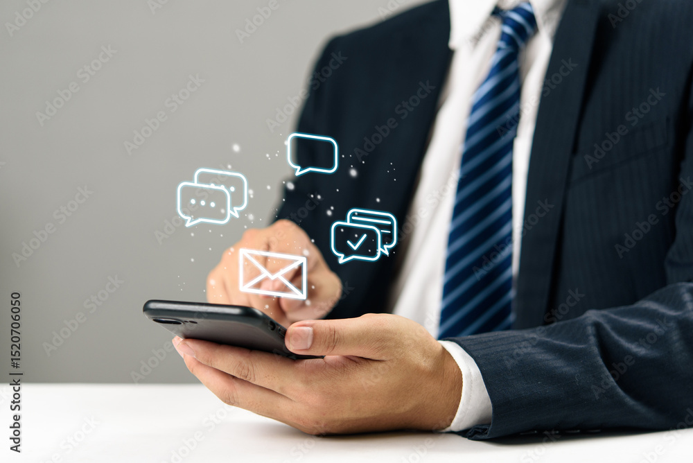 Businessman hand holding smartphone with digital chat and email icons, communication online messaging, social media, mobile marketing, and modern customer engagement technology. Businessman hand holding smartphone with digital chat and email icons, communication online messaging, social media, mobile marketing, and modern customer engagement technology.