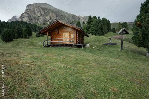 small house over a mountain pasture in Dolomites with wonderful panorama