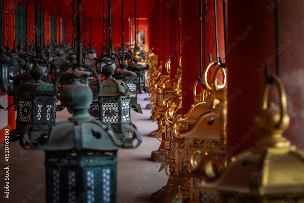 Fototapeta premium japanese traditional lanterns in a temple ; old ancient metal lanterns in an alley in japan