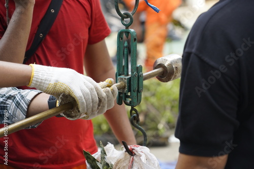 A team of workers is busy weighing goods in the warehouse