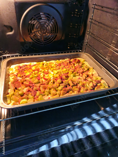 Homemade rhubarb pie in an oven