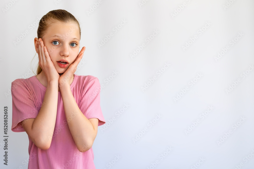 Shocked Girl With Hands on Her Face. Surprised young girl holding her face with both hands, expressing shock or amazement, isolated on a white background. Space for text. Shocked Girl With Hands on Her Face. Surprised young girl holding her face with both hands, expressing shock or amazement, isolated on a white background. Space for text.