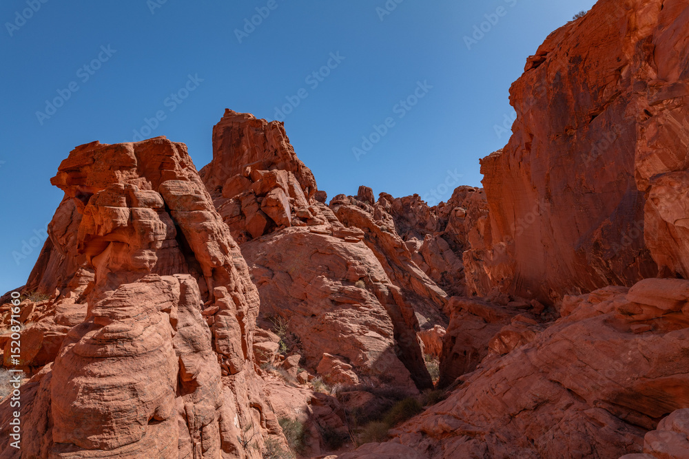 Desert varnish, red Aztec Sandstone outcrops. Rainbow Vista Trail, Valley of Fire State Park, Clark County, Nevada geology. Weathering joints Desert varnish, red Aztec Sandstone outcrops. Rainbow Vista Trail, Valley of Fire State Park, Clark County, Nevada geology. Weathering joints