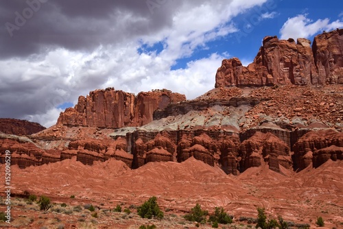 Fotografie colorful eroded red rock formations and ominous storm clouds on a sunny summer d
