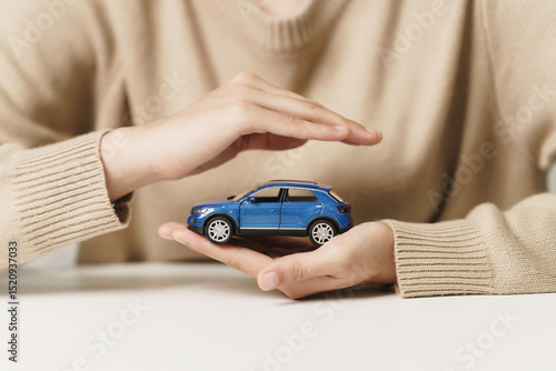 Wallpaper Mural Woman hand Protecting blue Car, symbol of Car Insurance and vehicle protection concept. Coverage for Auto Safety for Security, Protection against Accidents and Damages and financial saving. Torontodigital.ca