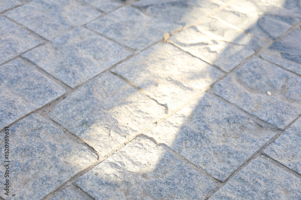 Obraz premium Sunlight Casting Shadow on Tiled Floor