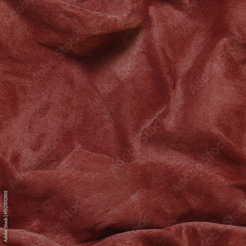 Rich seamless texture of crumpled fabric in warm reddish tones for design and artistic projects