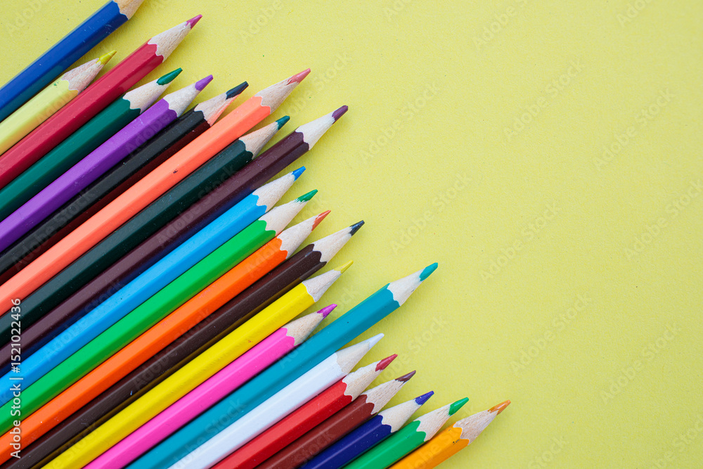 Colored pencils on a yellow background. Bright juicy background for inscriptions. Summer background. School. September 1. Office. Study. Colored pencils on a yellow background. Bright juicy background for inscriptions. Summer background. School. September 1. Office. Study.
