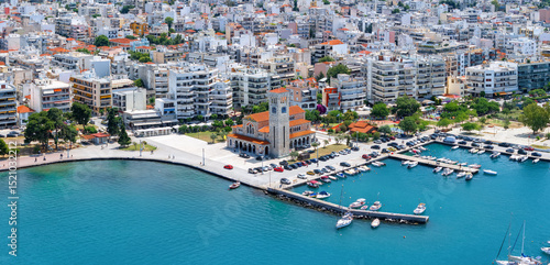 Fototapeta Naklejka Na Ścianę i Meble -  Aerial view of the cityscape of Volos, Greece, with marina waterfront and Agios Konstantinos church